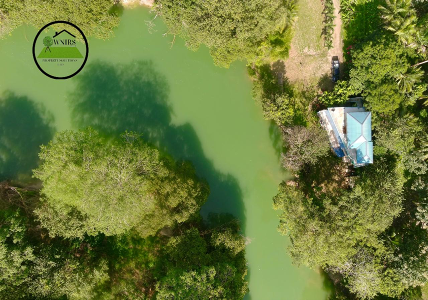 892.010 square meters  of land being Entry no. 12744 along the Mopan River and the Bullet Tree Falls/Santa Familia Road, Paslow Falls Area Cayo District